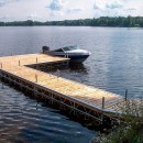 A boat parked at an L-shaped Pipe Dock.