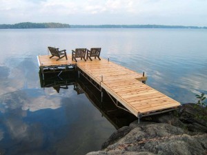 Three deck chairs on a Pipe Dock on Sparrow Lake.